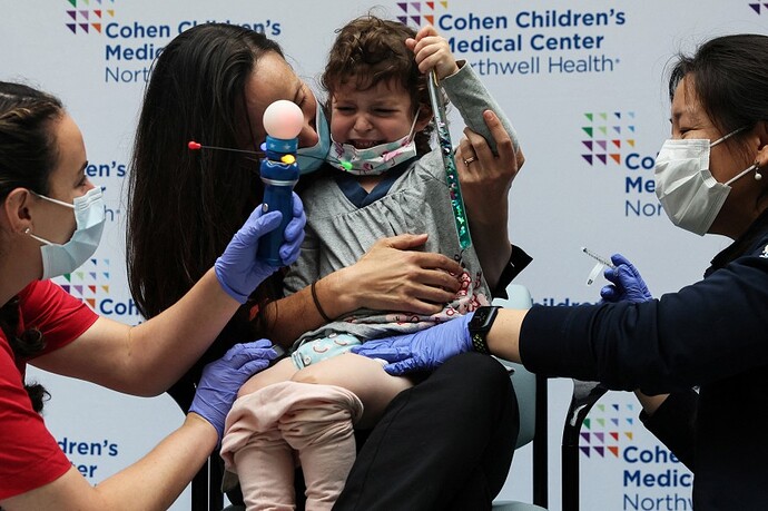 Jackie Katzow, 2, cries after receiving the vaccine against the coronavirus disease (COVID-19) at Northwell Health's Cohen Children's Medical Center in New Hyde Park, New York