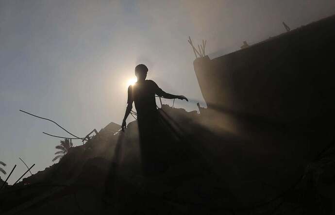 Silhouette of a Palestinian searching for his belongings after Israeli attack struck Khadija School, which also served as a field hospital in Deir al-Balah, Gaza, on July 27, 2024.